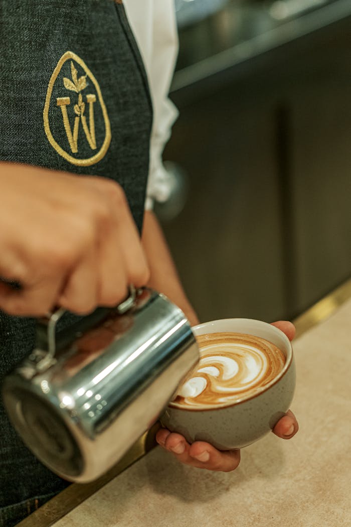 Close-up of a barista crafting latte art in a café in Baku, Azerbaijan.